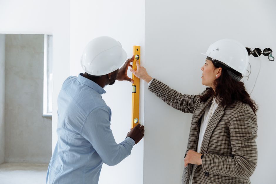 Contractor discussing home exterior and insulation project with homeowner